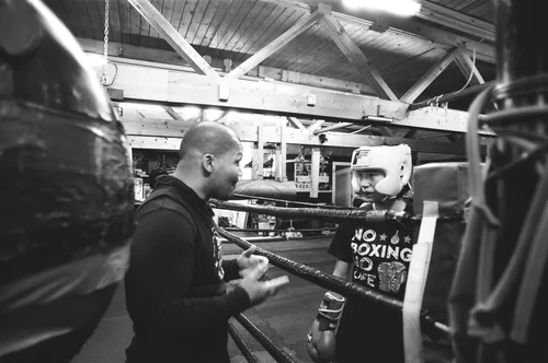 Coach Manny mentoring a boxer at Nomad Boxing Club